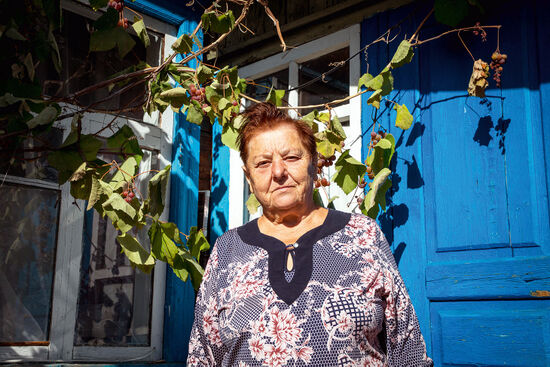 Sofia Bezverhaya outside her house in Kupovate, Kyiv Oblast, Ukraine (photo © Darmon Richter).