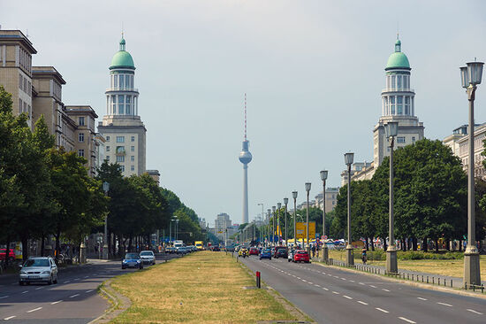 Looking west from Frankfurter Tor along Karl-Marx-Allee, Berlin. The two ceremonial towers were designed by Hermann Henselmann, who also did the initial design concept for the Alexanderplatz TV Tower in the distance (photo © Sergey Kohl /dreamstime.com).
