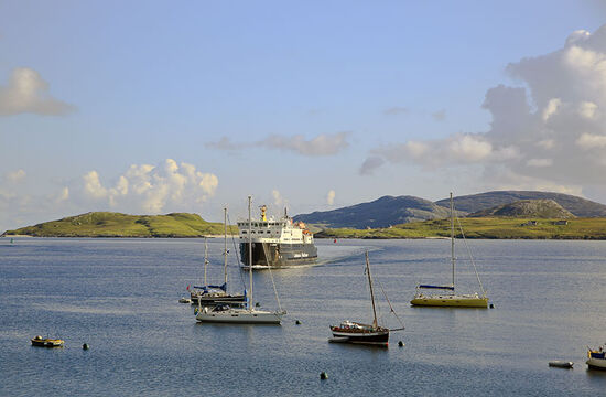 A CalMac ferry approaching the jetty in the harbour of Castlebay, Barra (photo © Donaldford / dreamstime.com).