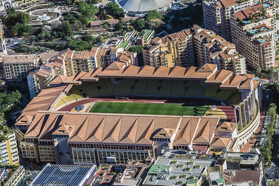 Monaco’s Louis II football stadium — the line of palm trees to the right of the structure is already in France (photo © Manjik / dreamstime.com).